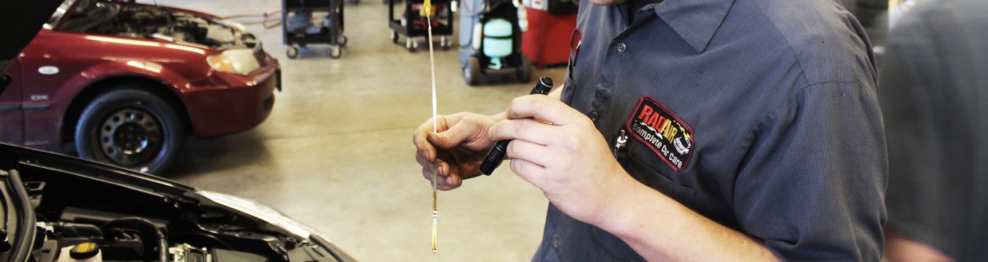Mechanic performing vehicle inspection at Rad Air