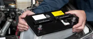 person holding a car battery