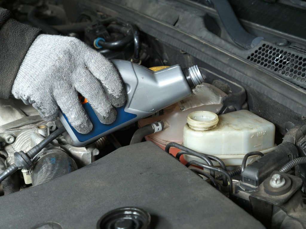 brake fluid being poured in a vehicle