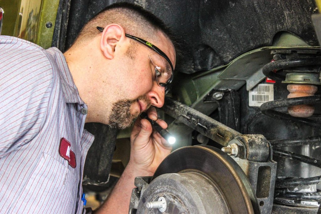 Rad Air technician inspecting brakes