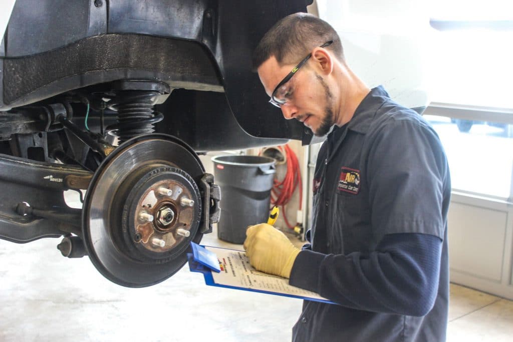 Rad Air technician inspecting brakes