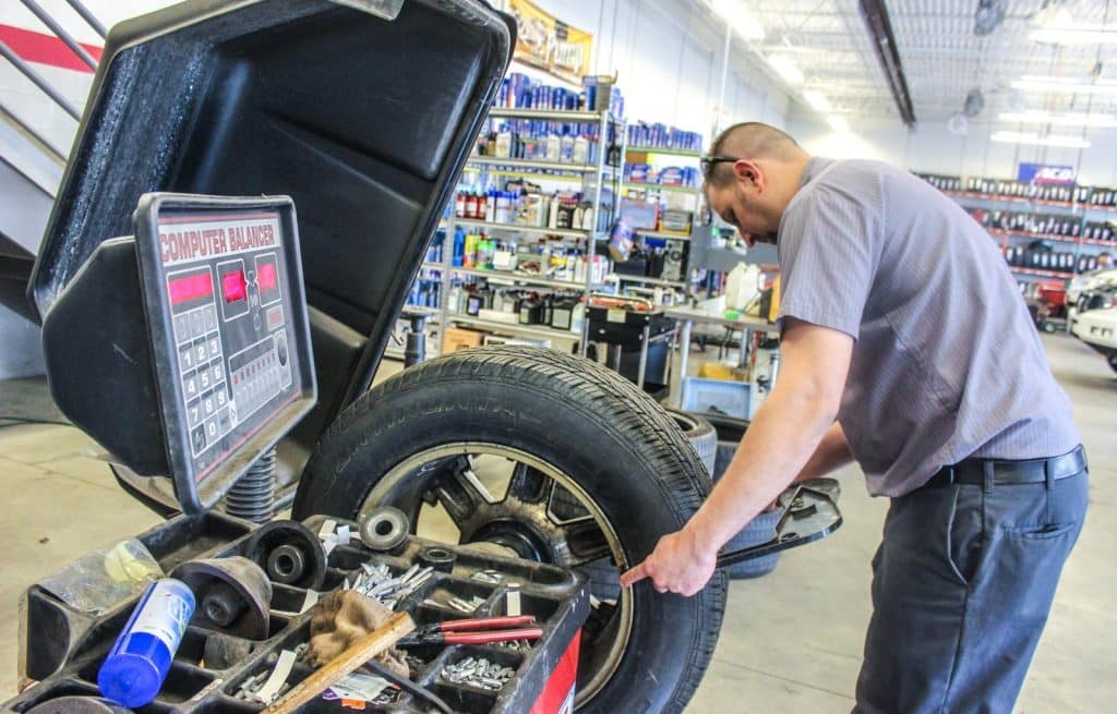 mechanic balancing a tire