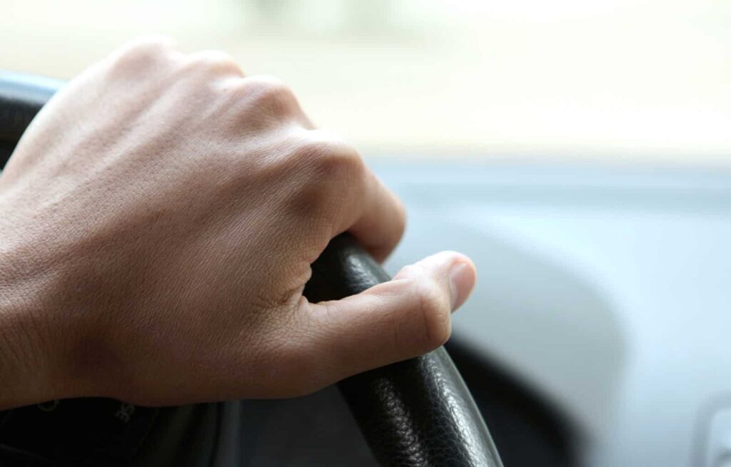 hand on steering wheel