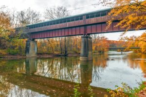 The Bridge of Dreams is a covered Bridge spanning over Mohican river in a fall season | Rad Air - STAGING The Bridge of Dreams is a covered Bridge spanning over Mohican river in a fall season